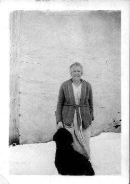 This is Grandma Harper and their dog near the house in winter-time
